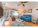 Living room with blue couch and view into kitchen area at 10036 63Rd N Ave # 23, St Petersburg, FL 33708