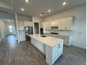 Modern kitchen featuring a large island and stainless steel appliances at 10260 Beach Dune Dr, Englewood, FL 34223