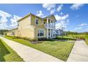 Side view of two-story house with landscaping and sidewalk at 3731 Tea Leaf Aly, Land O Lakes, FL 34638