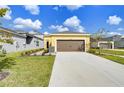 Attached two-car garage with a long driveway at 3731 Tea Leaf Aly, Land O Lakes, FL 34638