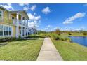 Home features a walkway alongside a canal, showcasing a peaceful waterfront view at 3731 Tea Leaf Aly, Land O Lakes, FL 34638