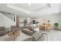 Bright, open-concept living room with modern furnishings and an adjacent kitchen area at 4187 Feldspar Ln, Spring Hill, FL 34609