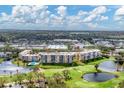 Aerial view of a condo community with pool, golf course, and nearby shopping at 4530 Pinebrook Cir # 208, Bradenton, FL 34209