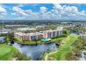 Aerial view of the community near a golf course and lake at 4530 Pinebrook Cir # 208, Bradenton, FL 34209