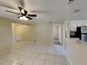 Open concept living area with tile floors and views into the kitchen at 5301 82Nd N Ave, Pinellas Park, FL 33781