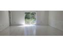Bright living room with sliding glass doors leading to backyard at 10024 Heathcliff St, Spring Hill, FL 34608