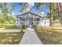Renovated light blue house with a metal roof, front porch, and landscaped yard at 106 E Calhoun St, Plant City, FL 33563