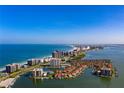 Aerial view of waterfront community with luxury high-rise buildings and private marina at 1460 Gulf Blvd # 210, Clearwater Beach, FL 33767