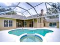 Inviting pool and spa area with a screened enclosure at 2821 Winding Trail Dr, Valrico, FL 33596