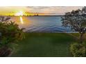 Scenic sunset view over calm water with lush green grass at 306 Blanca Ln, Tampa, FL 33606