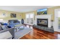 Cozy living room features a fireplace, hardwood floors, and comfortable seating at 3302 E Maritana Dr, St Pete Beach, FL 33706