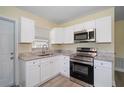 Renovated kitchen with white shaker cabinets and stainless steel appliances at 3305 W Kathleen St, Tampa, FL 33607