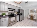 Functional kitchen featuring stainless steel appliances, updated cabinets, and adjacent breakfast nook for casual dining at 3454 Hillmoor Dr, Palm Harbor, FL 34685