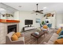 Bright living room with a fireplace, modern furniture, and neutral tones that create a cozy atmosphere at 3454 Hillmoor Dr, Palm Harbor, FL 34685