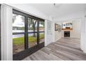 Bright living room with a fireplace and a beautiful view of the lake at 3454 Hillmoor Dr, Palm Harbor, FL 34685