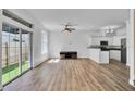 Bright living room boasts wood floors, sliding glass doors to the backyard, and a ceiling fan at 411 S Fremont Ave # B, Tampa, FL 33606