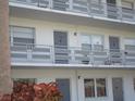 Exterior view of a light-grey building with multiple balconies and individual apartment numbers at 6000 20Th N St # 129, St Petersburg, FL 33714