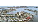 Aerial view showing home's location near waterfront with exclusive boat launch at 745 Sunset Cv, Madeira Beach, FL 33708