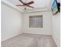 Spacious bedroom with ceiling fan and window shutters at 2468 Kensington Greens Dr, Sun City Center, FL 33573
