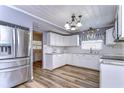 Updated kitchen with white cabinets, stainless steel appliances, and granite countertops at 33137 Cercelia Rd, Dade City, FL 33523