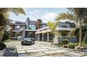 Luxury home with modern design, three-car garage, and landscaped grounds at 4441 Pompano Se Dr, St Petersburg, FL 33705