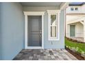 Welcoming entryway featuring a gray front door and a decorative sidelight window at 10316 Cross River Trl, Parrish, FL 34219
