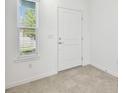 Bright foyer with a white door, tile flooring and a window offering natural light at 10316 Cross River Trl, Parrish, FL 34219