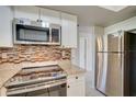 Stainless steel appliances and granite countertops in a renovated kitchen at 18138 Lake Worth Blvd, Port Charlotte, FL 33948