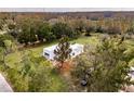 Aerial view of a single-story modern white house at 19234 Causeway Blvd, Land O Lakes, FL 34638