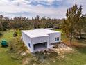 Aerial view of a single-story modern house under construction at 19234 Causeway Blvd, Land O Lakes, FL 34638