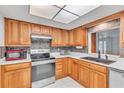 Updated kitchen with wood cabinets and stainless steel appliances at 3078 Eastland Blvd # 304, Clearwater, FL 33761