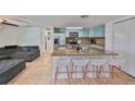 Modern kitchen with granite countertops and breakfast bar at 3207 Acacia St, Lutz, FL 33558