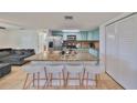 Bright kitchen with granite countertops, stainless steel appliances, and light teal cabinets at 3207 Acacia St, Lutz, FL 33558