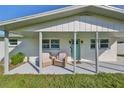 Inviting front porch with seating area, perfect for relaxing at 3207 Acacia St, Lutz, FL 33558