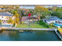Waterfront property with a private dock and lush green lawn at 52 Sandpiper Rd, Tampa, FL 33609