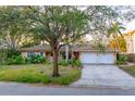 Charming single-story home featuring a lush front yard, two-car garage, and well-maintained landscaping at 52 Sandpiper Rd, Tampa, FL 33609