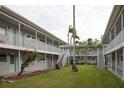 Courtyard with grassy area and two staircases leading to apartments at 5912 5Th N Ave # E9, St Petersburg, FL 33710