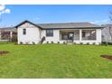 Modern home with large backyard, covered patio and lush landscaping at 6773 Summit View Dr, Brooksville, FL 34601