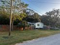 House exterior with wooden fence and grassy yard at 9131 Kosimo St, New Port Richey, FL 34654