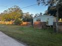 Mobile home with fenced yard and mature trees at 9131 Kosimo St, New Port Richey, FL 34654