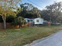 House exterior with wooden fence and grassy yard at 9131 Kosimo St, New Port Richey, FL 34654