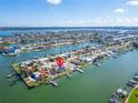 Aerial view of waterfront home with private dock and beautiful landscaping at 12520 4Th E St, Treasure Island, FL 33706
