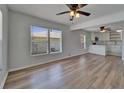 Bright, open-concept living room featuring wood-look floors and contemporary ceiling fans at 1312 E Louise Ave, Tampa, FL 33603