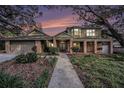Two story house with landscaping and walkway at dusk at 13811 Shady Shores Dr, Tampa, FL 33613