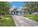 Newly renovated light-blue house with stone accents and a long driveway at 1611 Cedar Dr, Plant City, FL 33563