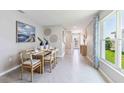 Bright dining room with wood table and modern decor, offering backyard views at 5264 Salt Marsh Rd, Wimauma, FL 33598