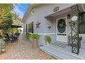 Front entrance with a patio, seating area, and brick paving at 860 25Th N Ave, St Petersburg, FL 33704