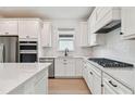 Bright kitchen features white cabinets, subway tile backsplash, stainless appliances, and a large island at 9434 Shorebird Ct, Parrish, FL 34219