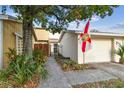 Townhouse exterior with walkway, gate, and Florida flag at 99 Davis E Blvd # A, Tampa, FL 33606