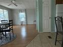Bright dining area with laminate floors and a view into the living room at 12501 Ulmerton Rd # 119, Largo, FL 33774